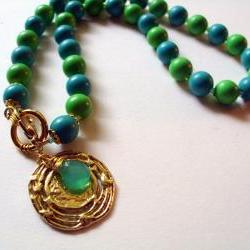 Gold disc lariat necklace with blue and green vintage beads